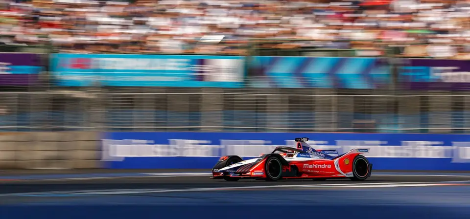 A Formula E car at speed on the Berlin ePrix circuit, alongside the first festival