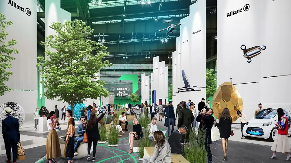 Exhibition stands and planted trees inside the Tempelhof hangar