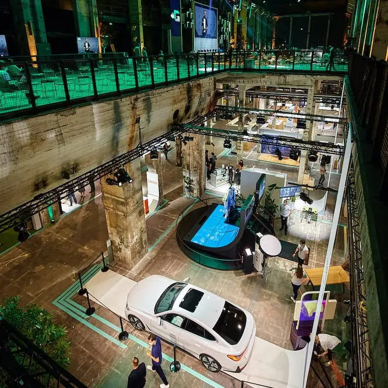 A car on show in the galleried hall, seen from above