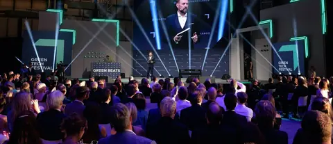 A speaker on the Green Beats stage in front of a seated audience, GREENTECH FESTIVAL 2022