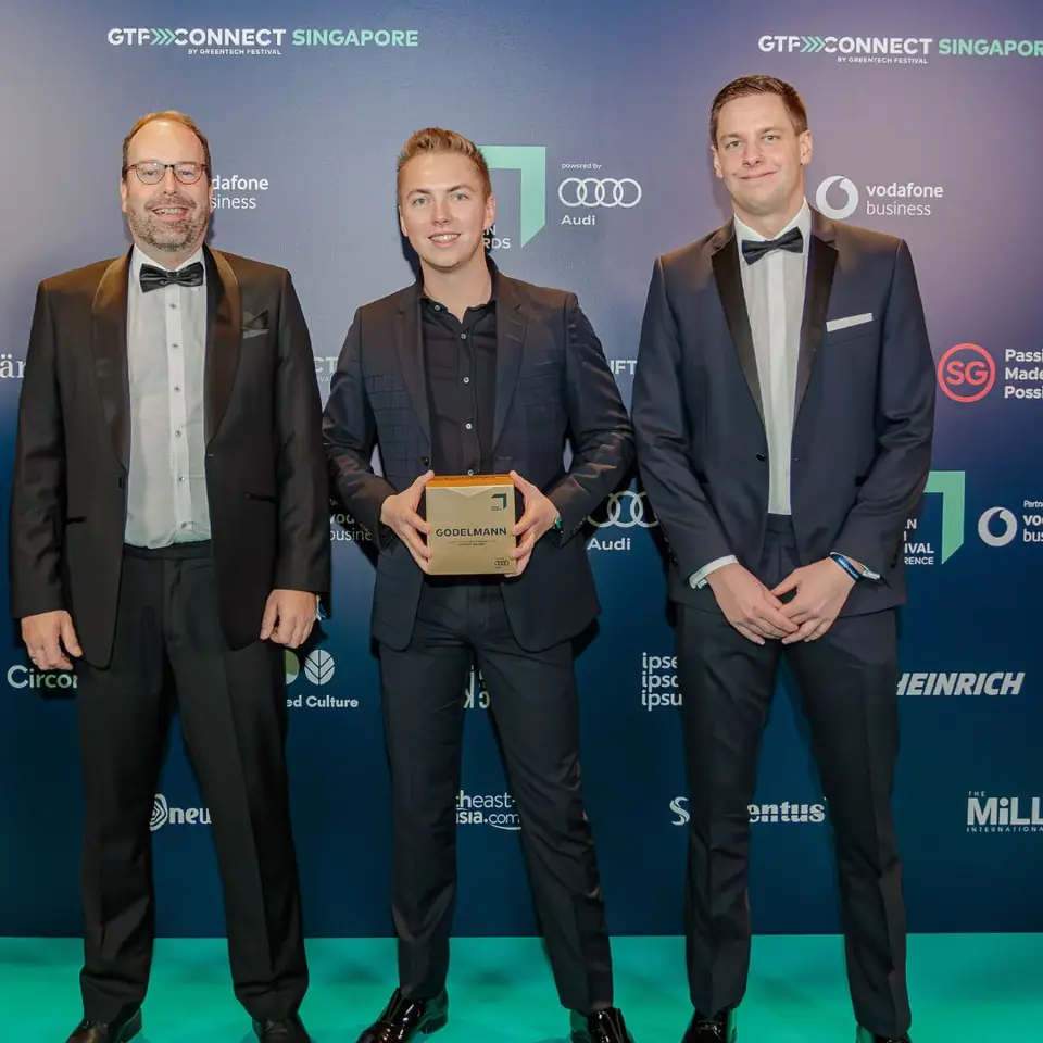A winner with the trophy at the GTF Connect Singapore wall