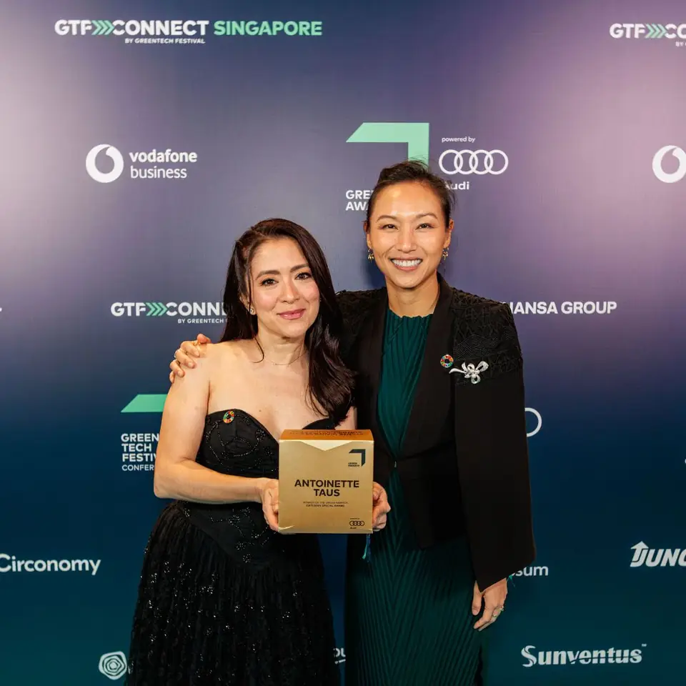 A winner with the trophy at the GTF Connect Singapore wall