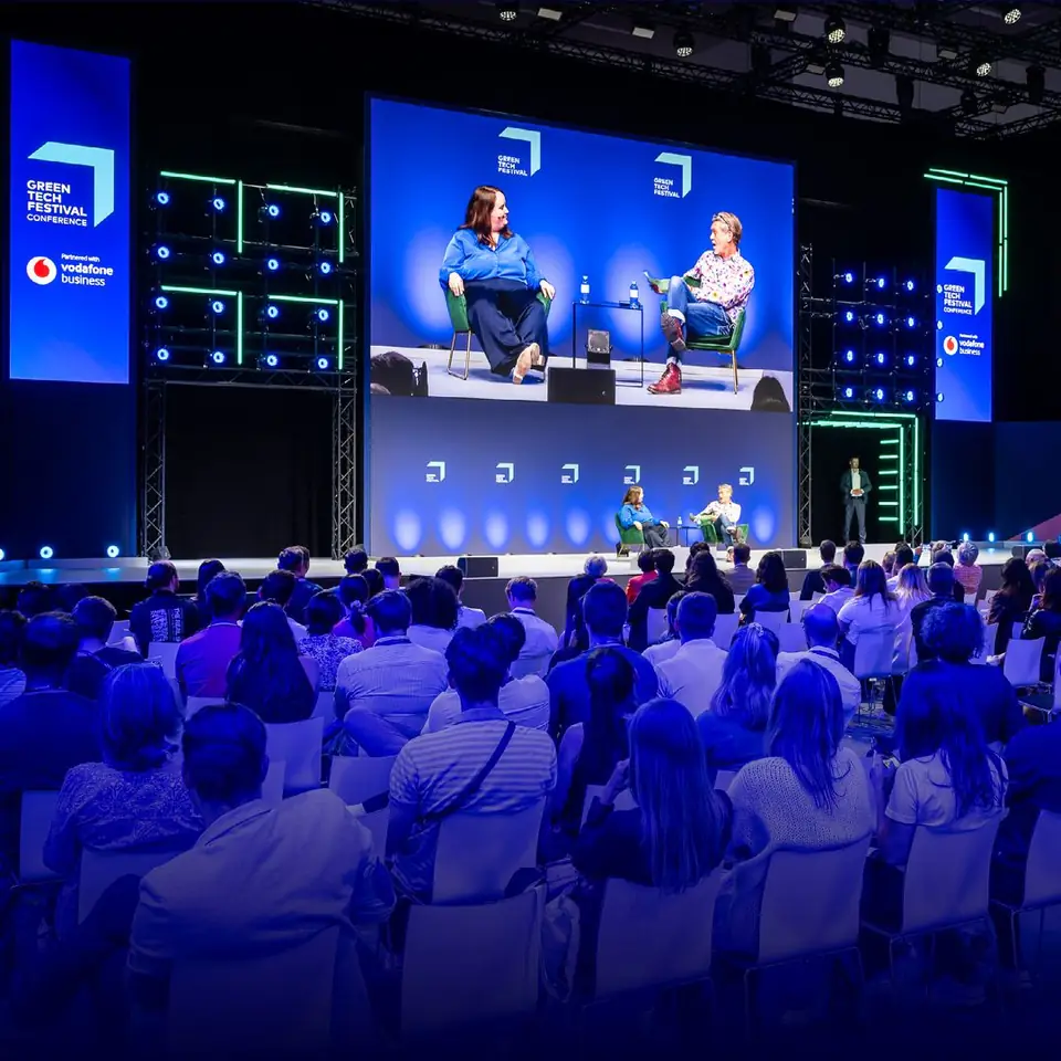 A panel on the main stage in front of a full hall