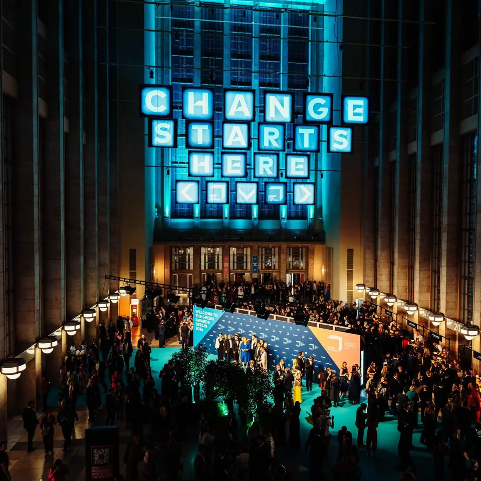 Change Starts Here, lit above a full hall
